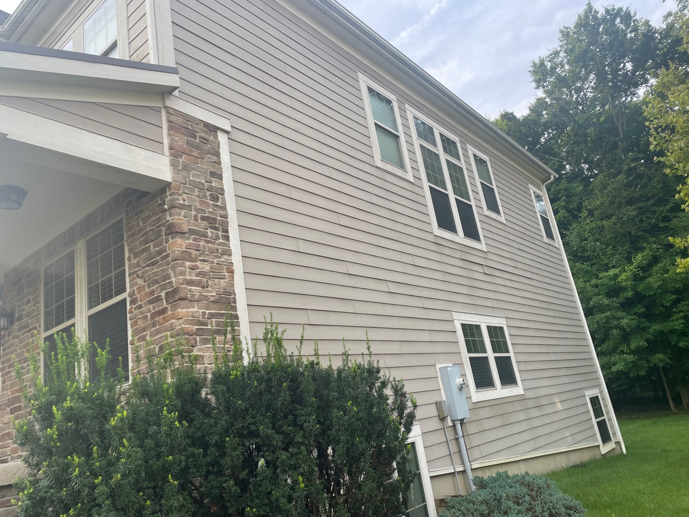 Pinnacle Wash soft-washing the brick exterior of an older home in Columbus, OH